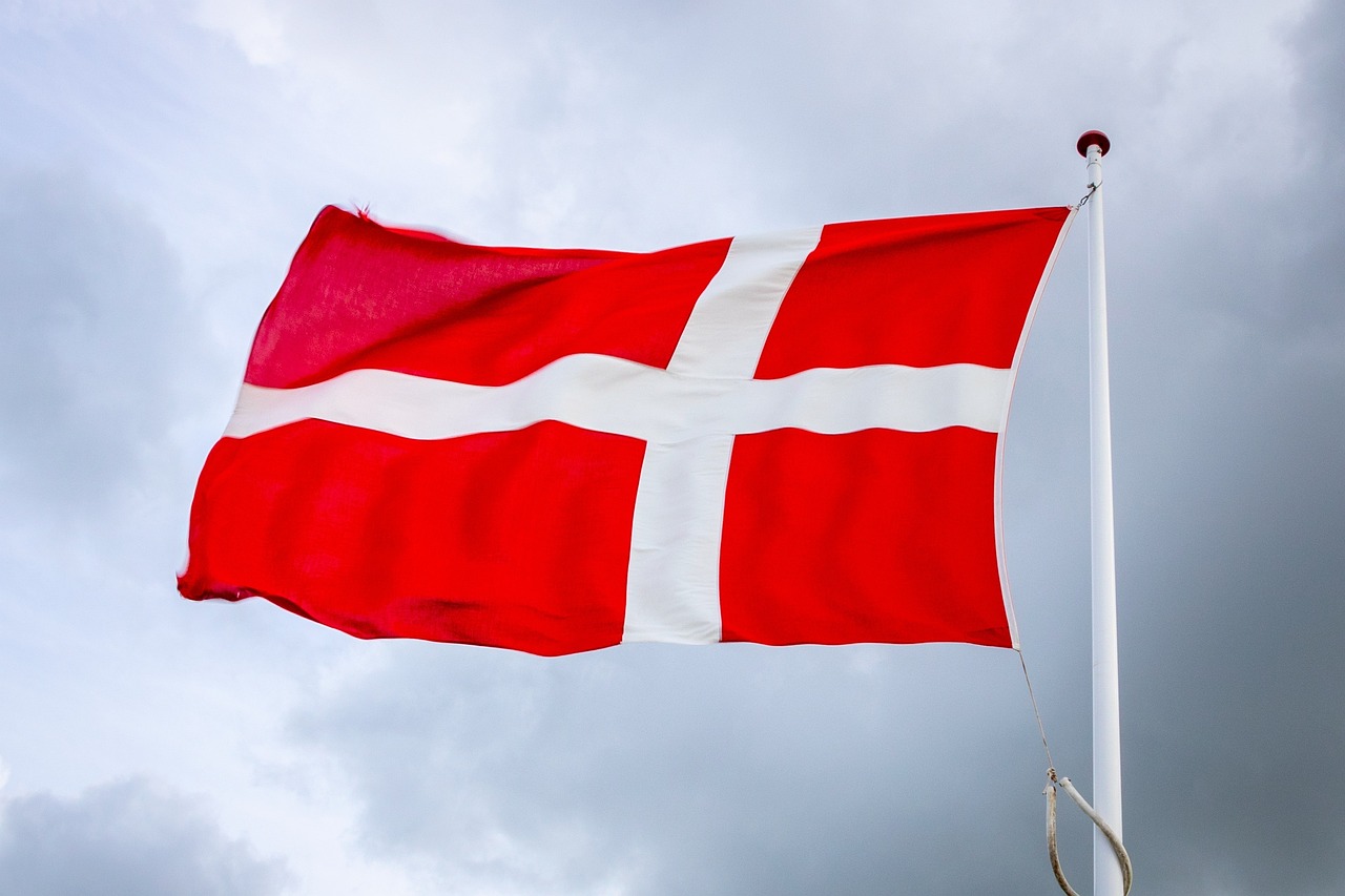 Danish flag, the Dannebrog, flying against a blue sky