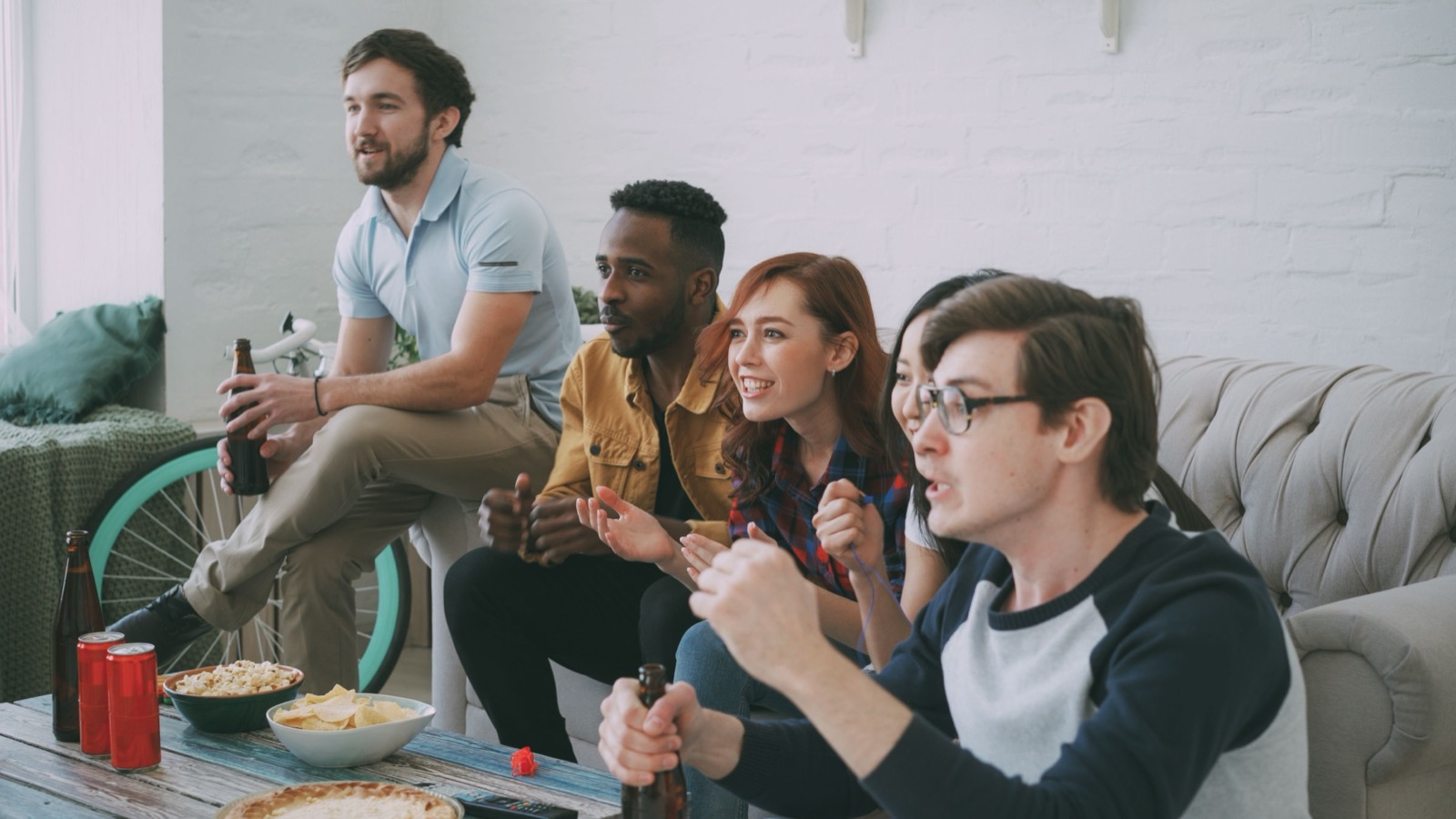 Group of friends watching live sports together via IPTV UK streaming service