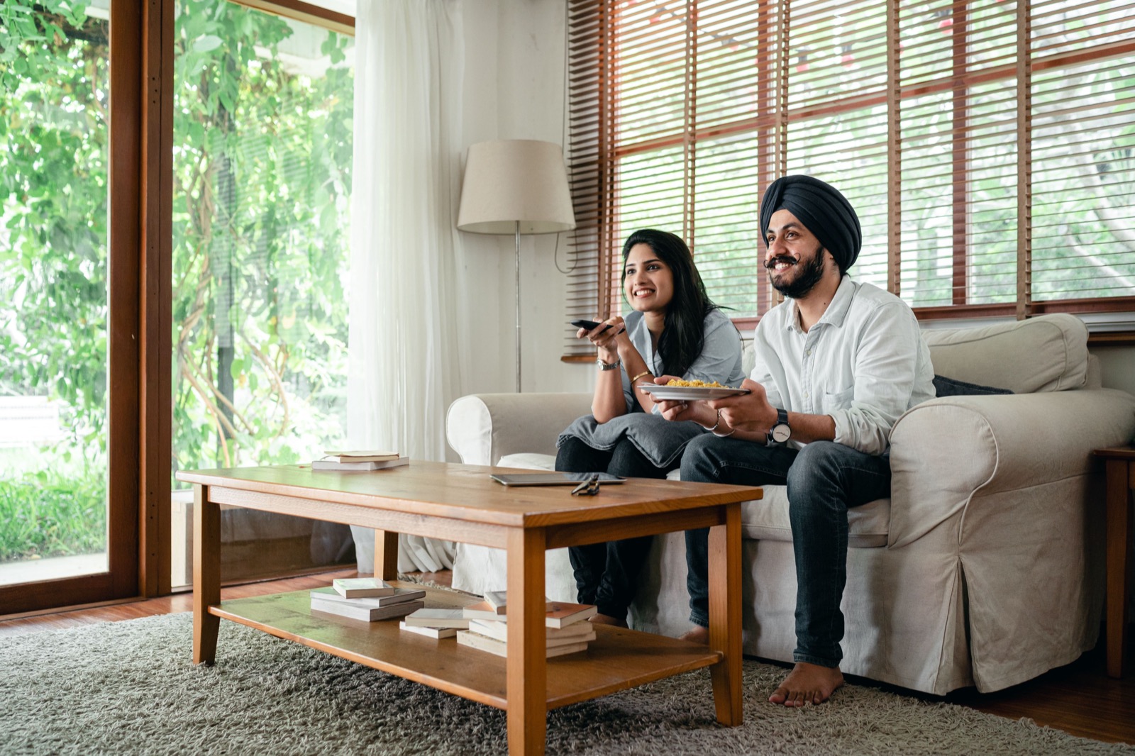Canadian viewer browsing IPTV channel guide on a smart TV remote, selecting live TV content