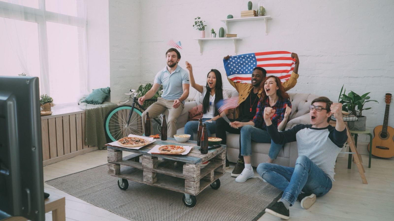 Group of friends watching an international sports event via IPTV streaming in Denmark
