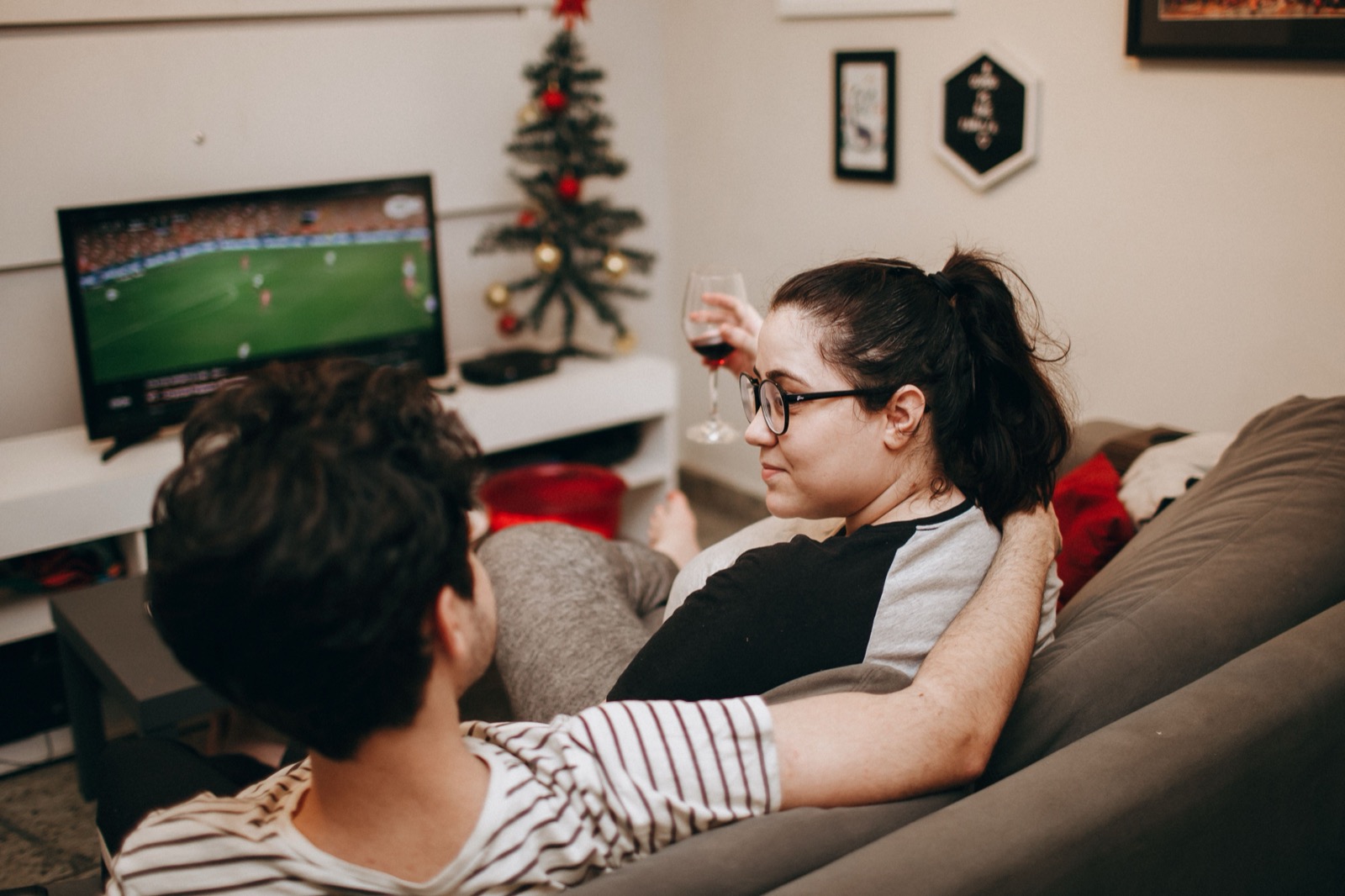 Couple relaxing on a couch watching legal IPTV streaming service together