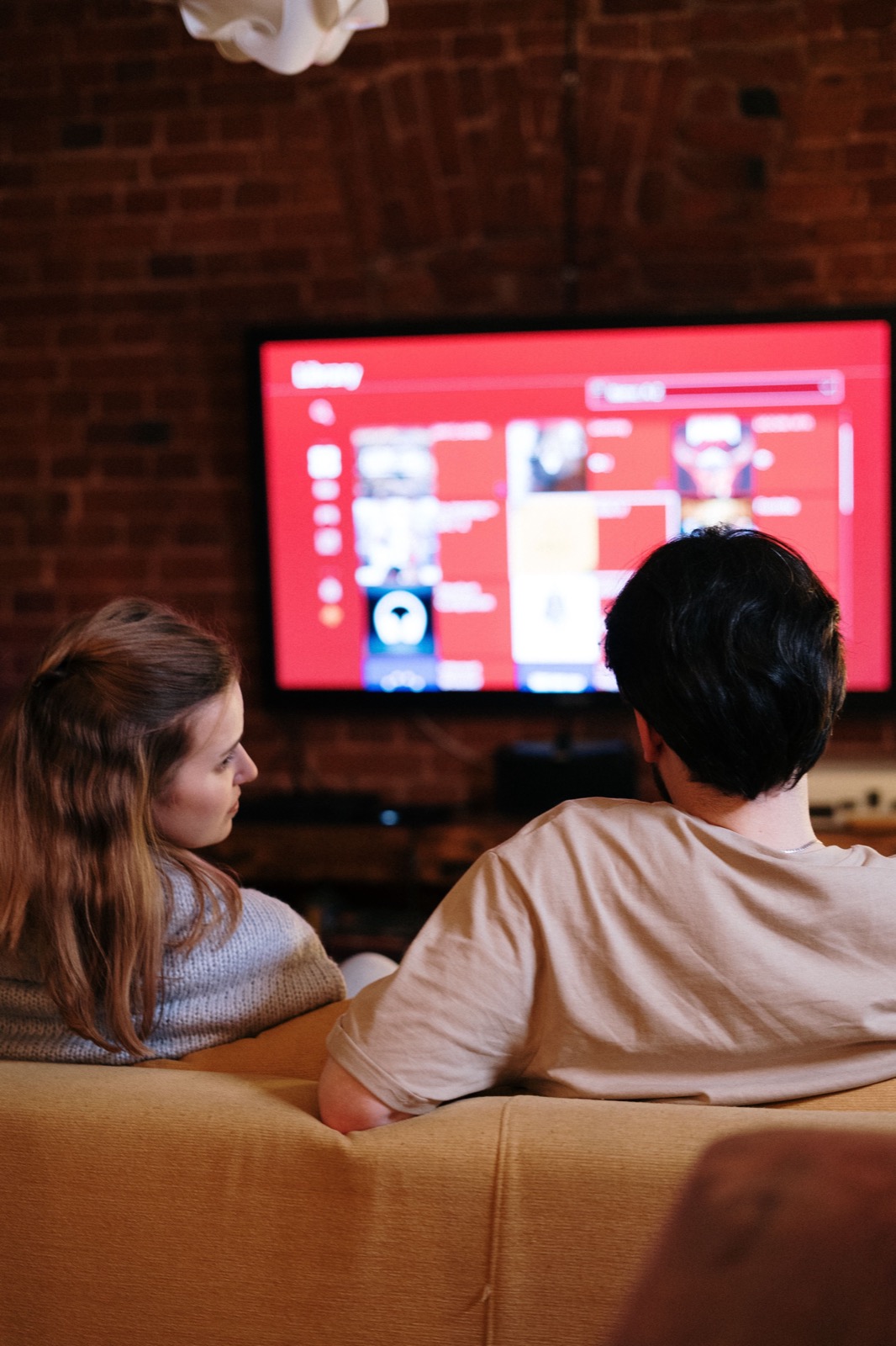 Person browsing IPTV streaming content on a large smart TV at home