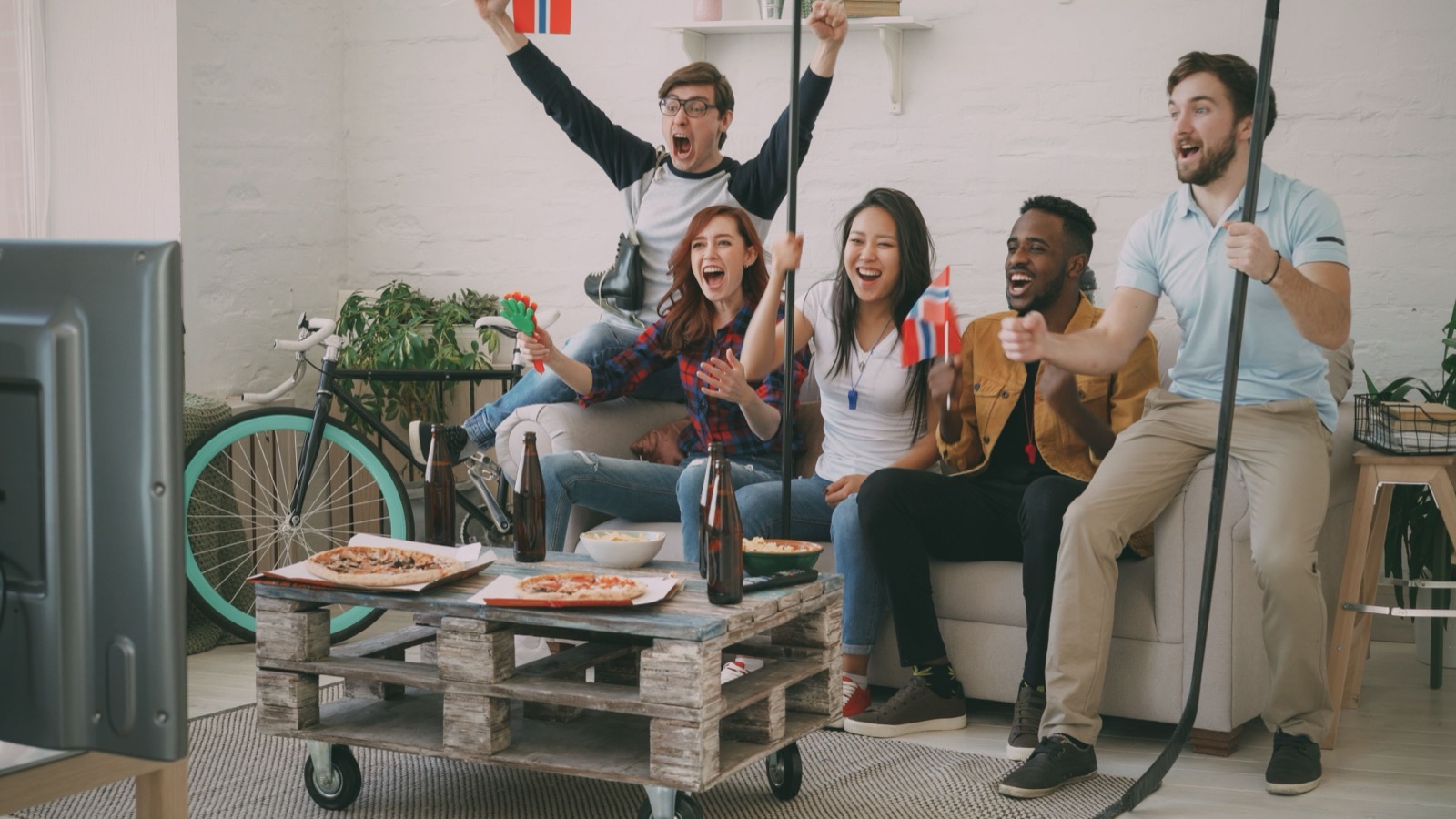 Group of friends watching live sports on IPTV streaming service using Xtream Codes or M3U connection